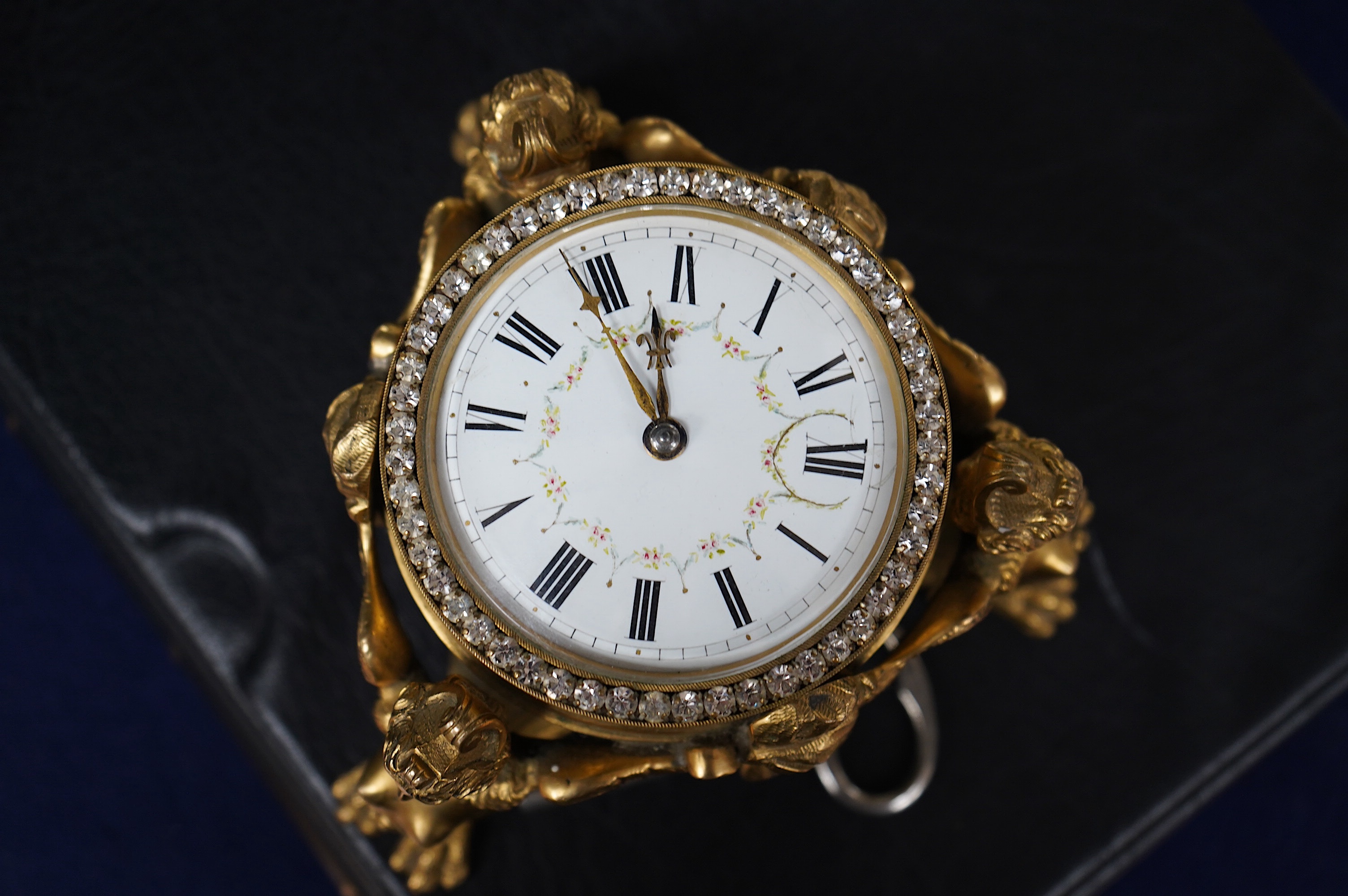 A 19th century French ormolu table timepiece decorated with paste jewelling edged dial and three classical figures, widest point 15cm. Condition - good, not been checked as working